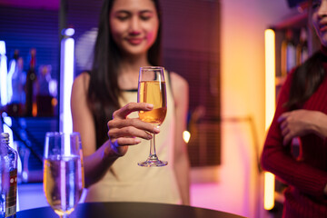 Asian women celebrating, meeting and chatting in a bar. Places to visit, beautiful lights