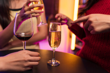 Asian women celebrating, meeting and chatting in a bar. Places to visit, beautiful lights