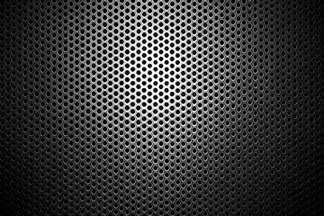 Naklejka premium A textured black metal surface with circular perforations, creating a modern, industrial look.