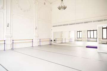 Studio with white walls and open space for ballet and yoga classes
