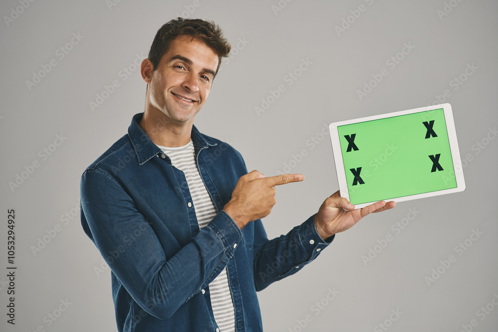 Poster portrait, green screen and man with tablet, pointing and happy person on gray studio background. fac