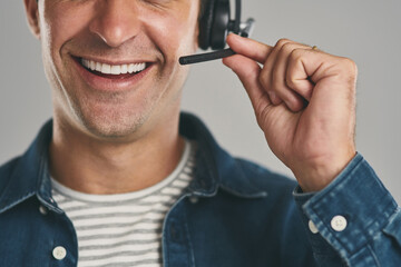 Call center, man and mouth in studio with smile on headset for customer service or advice on white...