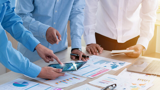 Teamwork meeting concept. Business team working together while talking about financial chart. Collaboration or diversity in workplace community. problem-solving, volunteer. Unity, team business. - Powered by Adobe