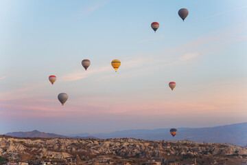 Colorful hot air balloons fly gracefully over a vibrant skyline in valley Cappadocia Turkey