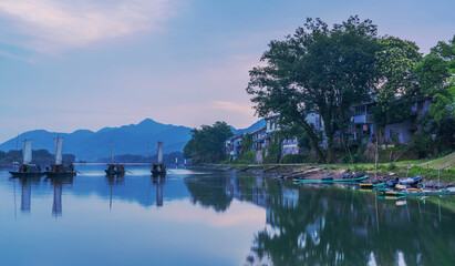 Fototapeta premium The mountains, Oujiang River, and fishing boats in Lishui City, Zhejiang Province, China 