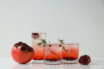 Red cocktail with fresh pomegranate on a white background