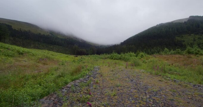 Wide shot looking at low level cloud looking in between blake fell and blake crag at Cogra Moss lake. West lake district