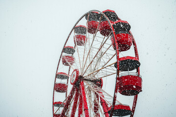 Lonely Ferris Wheel Halts Against White Sky as Rain Falls Softly: A Captivating Image of Solitude