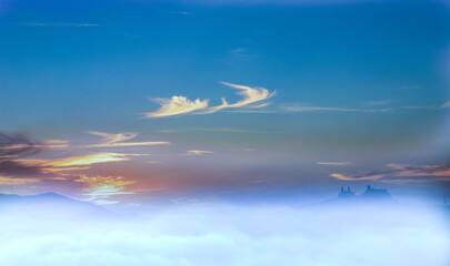 Fototapeta premium Beauty white cloudy on blue sky with soft sun light, Nature view soft white clouds on pastel blue sky background .Colorful cloudy sky at sunset. Gradient color. Sky texture, abstract nature backgroun 