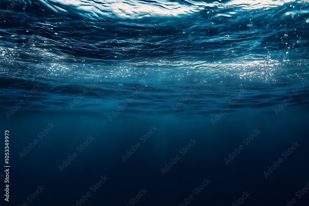 Wall mural sunlight shining through the water surface of deep blue ocean background with empty space for edit a
