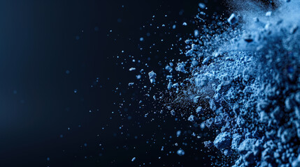 Blue dust powder explosion creates stunning visual effect against dark background, showcasing dynamic movement and texture of particles. scene evokes sense of energy and creativity