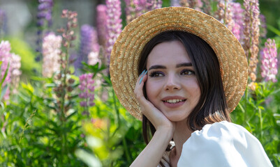 Portrait of a girl wearing a straw hat in lupine colors