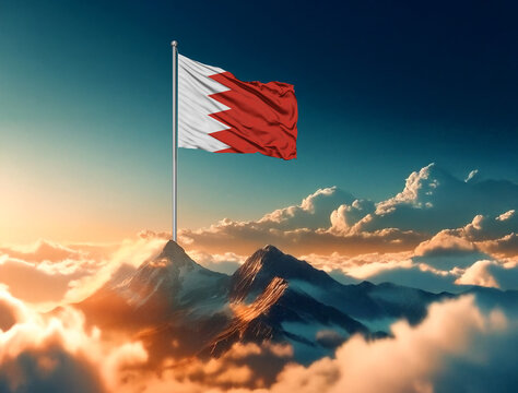 The majestic Bahrain flag proudly flies over the mountain tops, illuminated by a golden sunrise among the clouds. A national holiday. Celebration concept.
