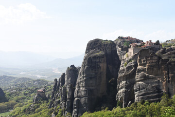 Naklejka premium small temples sitting on top of a mountain in meteora, greece
