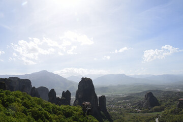 a majestic view of the mountains from the top of a hill in meteora, greece