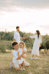 Parents, kids and happy family in park, garden and sunshine field outdoors for bonding, love and quality time together. Mom, dad and girl child of black family having fun, relax and care in nature