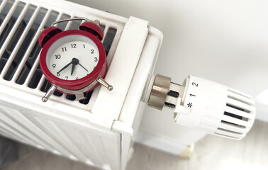 House heating inclusion concept. Battery clock to heat the room