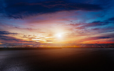 Asphalt highway road and sky clouds at sunset . Straight asphalt highway road and snow mountains with sky clouds natural landscape. car background. Serene Asphalt Road at Sunrise In dark blue
