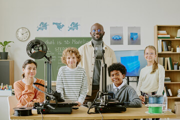 Multi-ethnic students learning 3D modeling with devices and technology in classroom setting....