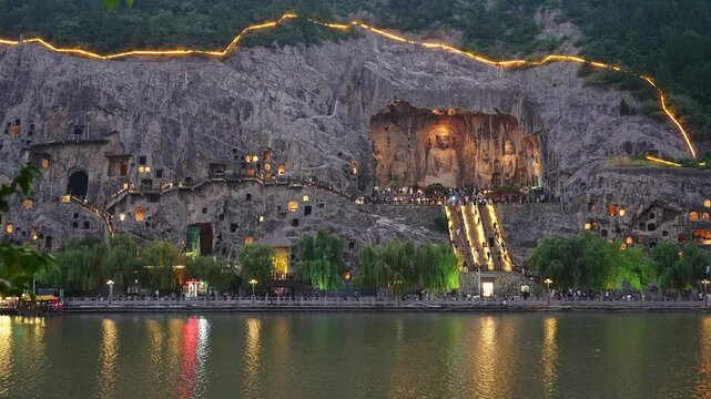 Luoyang, China: Evening view of the famous Vairocana Buddha statue and the multiples caves in the Luoyang Longmen Grottoes along the Yi river in China.