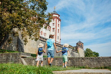 Kids enjoy old castle, during family trip in Wurzburg, Germany