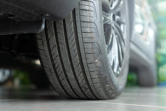 A car tire tread, highlighting the importance of inspecting wheels and tire condition before travel. Emphasizes road safety and vehicle readiness for the journey ahead