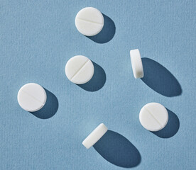 white pills on blue background