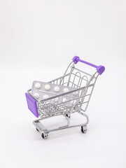 Iron consumer trolley with medicines on white background