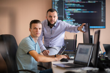 Programmers engrossed in deep collaboration, diligently working together to solve complex problems 