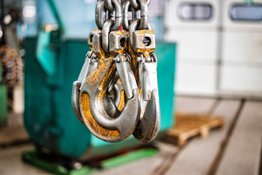 Lifting device hooks in an industrial workshop used for lifting heavy loads during daily operations