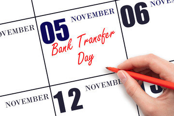 November 5. Hand writing text Bank Transfer Day on calendar date. Save the date.