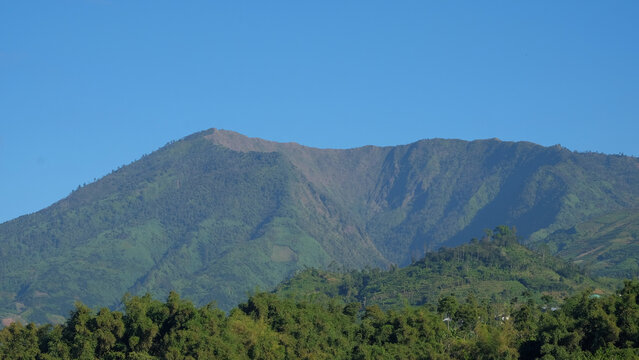 Scenic mountain landscape under a clear blue sky. Natural outdoor concept with majestic peaks, open horizon, and peaceful alpine scenery. Mount Bismo Peak view in Central Java Indonesia