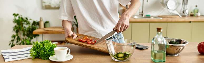 In a sleek kitchen, a young man enthusiastically crafts a vibrant salad using fresh ingredients.