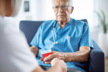 Fototapeta premium The measuring blood sugar levels in elderly people in a nursing home where an elderly man in a blue shirt