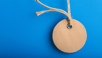 Craft paper tag tag mockup. Brown cardboard label. Blue backdrop. Empty space for text.