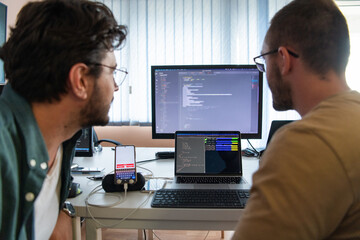 Obraz premium Programmers engrossed in deep collaboration, diligently working together to solve complex problems and develop innovative mobile applications with seamless functionality.