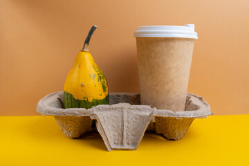 Pumpkin spice latte in a paper cup. Hot drink to go. Space for logo and inscription