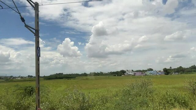 4k video clip of architecture, nature and farming fields view from the running train window.