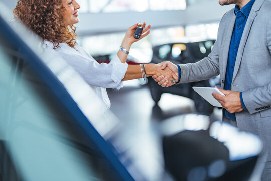 Successful Car Deal Handshake Inside Modern Showroom