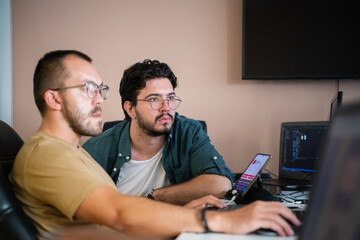 Programmers engrossed in deep collaboration, diligently working together to solve complex problems...