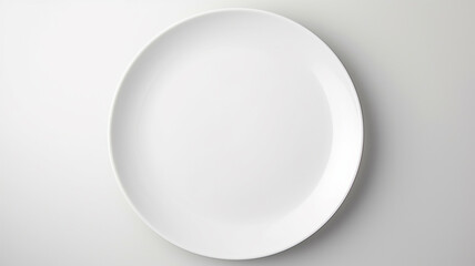 Fototapeta premium A white empty round plate on a white background, an image with copy space