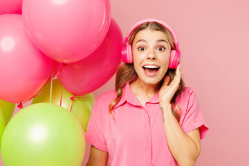 Close up young surprised woman wear shirt celebrating birthday holiday and hold bunch of colorful...
