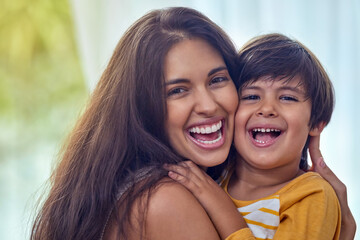 Fototapeta premium Hug, happy and portrait of mom with child for bonding, loving relationship and relax together in home. Family, laughing and mother with young boy embrace for love, affection and care in living room