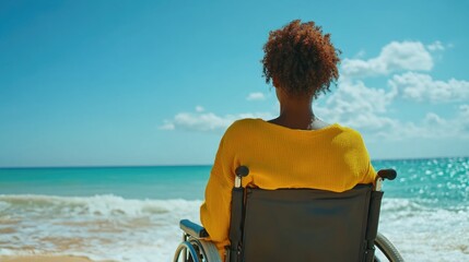 A woman relaxing in her wheelchair on a sunny beach