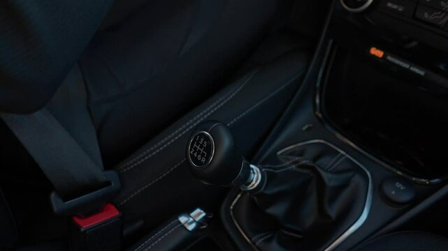 Hand of woman shifting gear car. Female person driving vehicle closeup. Driving the car and changing gear. Driver driving SUV automobile stick shift transmission