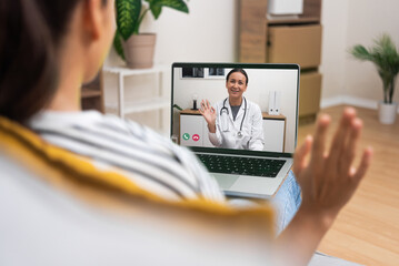 Young woman engaging in a friendly video call with her doctor, highlighting the personal touch in...