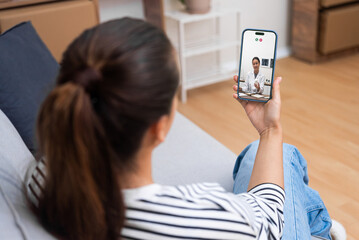 Telehealth appointment with a doctor discussing medication over a smartphone video call.