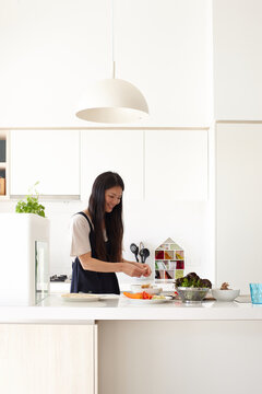 Mother in kitchen preparing meal