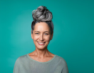 Fototapeta premium Studio Portrait of Beautiful Mature Older Woman Smiling Against Colored Background 