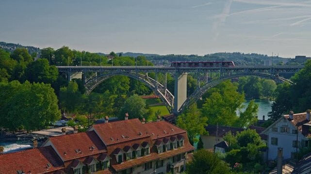 Bern medieval old town with a tramway and traditional red roofsdriving on the Kirchenfeld bridge above the Aar river in Switzerland capital city